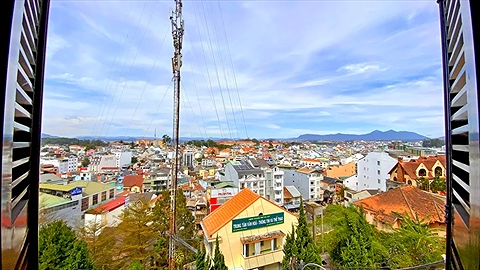 Toàn cảnh phố núi thu nhỏ qua khung cửa sổ